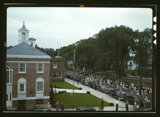 An American town and its way of life, Southington, Conn. The Memorial Day parade moving down the main street. The small number of spectators is accounted for by the fact that the town's war factories did not close. The town hall is in the left foreground. May 23 to May 30