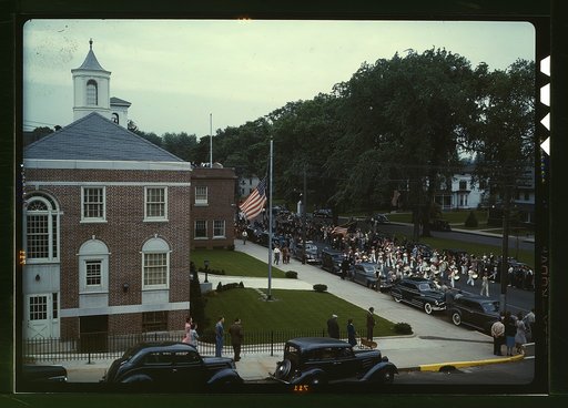 An American town and its way of life, Southington, Conn. The Memorial Day parade moving down the main street. The small number of spectators is accounted for by the fact that the town's war factories did not close. The town hall is in the left foreground. May 23 to May 30