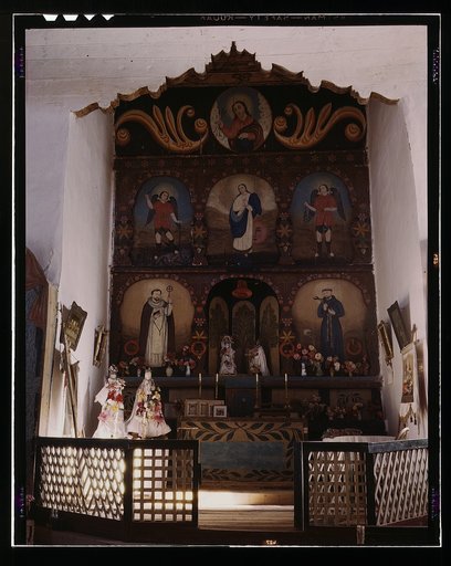 The main altar in the church, Trampas, N.M. There are paintings on the wall behind the altar