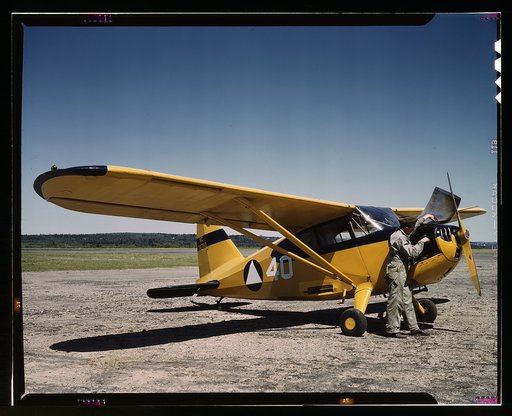 Civil Air Patrol Base, Bar Harbor, Maine. Ground crew making a routine overhaul of a patrol plane at base headquarters of Coastal Patrol #20