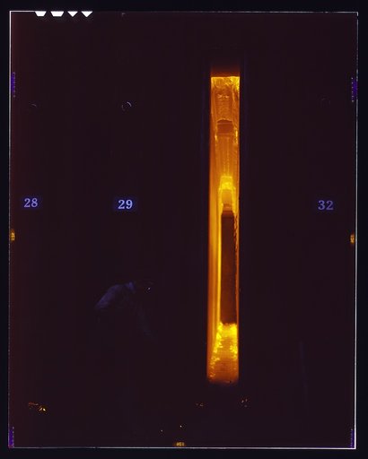 Hanna furnaces of the Great Lakes Steel Corporation, Detroit, Mich. Cleaning out loose coke after removing a door preparatory to putting door back