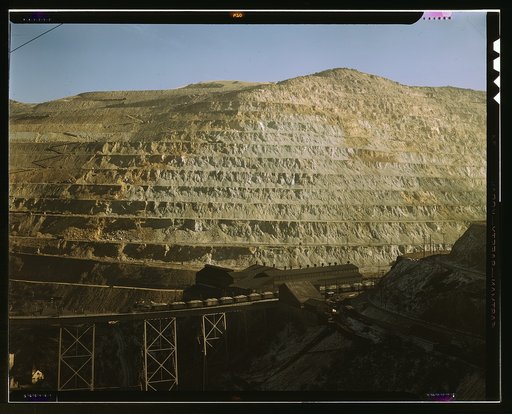 Open-pit workings of the Utah Copper Company, Bingham Canyon, Utah. This is the Carr Fork side from which the company obtains huge amounts of ore. The Carr Fork bridge and main shops appear in the foreground