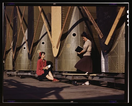 Girl inspectors at the Long Beach, Calif., plant of Douglas Aircraft Company make a careful check of center wings for C-47 transport planes