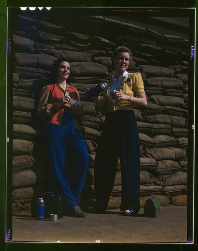 Lunchtime brings a few minutes of rest for these women workers of the assembly line at Douglas Aircraft Company's plant, Long Beach, Calif. Sand bags for protection against air raid form the background. Most important of the many types of aircraft made at this plant are the B-17F ("Flying Fortress")