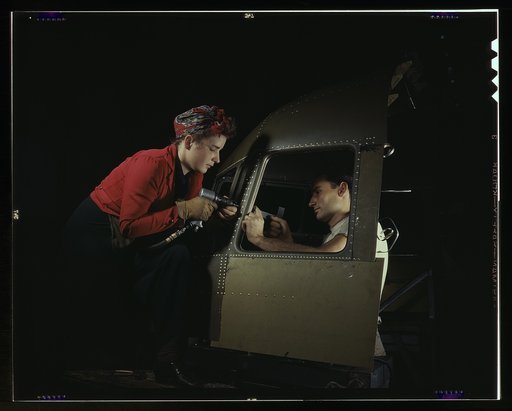 Men and women make efficient operating teams on riveting and other jobs at the Douglas Aircraft plant, Long Beach, Calif. Most important of the many types of aircraft made at this plant are the B-17F ("Flying Fortress") heavy bomber, the A-20 ("Havoc") assault bomber and the C-47 heavy transport pla