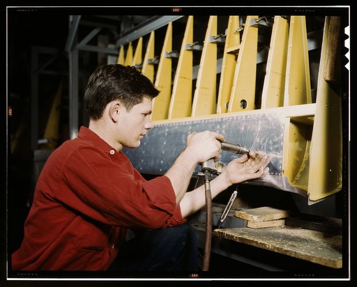 Riveter at work at the Douglas Aircraft Corporation plant in Long Beach, Calif.