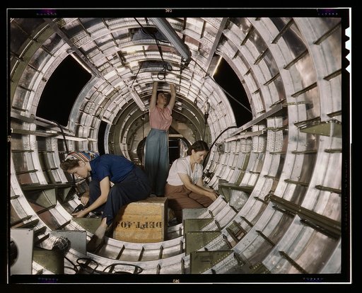 Women workers install fixtures and assemblies to a tail fuselage section of a B-17F bomber at the Douglas Aircraft Company, Long Beach, Calif. Better known as the "Flying Fortress," the B-17F is a later model of the B-17 which distinguished itself in action in the South Pacific, over Germany and els