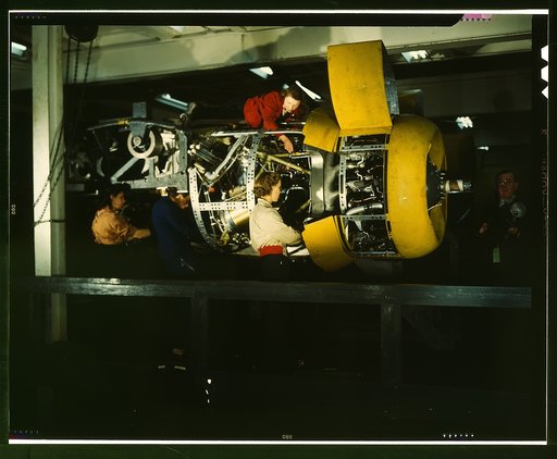 Installing one of the 4 motors on the transport plane at Willow Run
