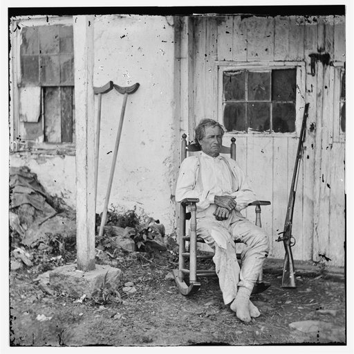 Gettysburg, Pa. John L. Burns, the "old hero of Gettysburg," with gun and crutches
