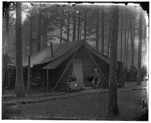 Brandy Station, Va. Col. John R. Coxe, A.C.S., and lady seated before his log-cabin winter quarters at Army of the Potomac headquarters