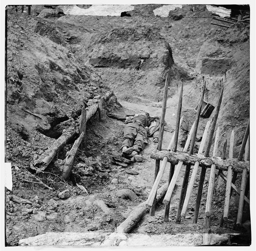 Petersburg, Va. Dead Confederate soldier, in trench beyond a section of chevaux-de-frise