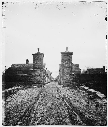 Saint Augustine, Fla. Entrance gate, with street and houses beyond