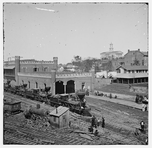 Nashville, Tenn. Railroad yard and depot with locomotives; the Capitol in distance