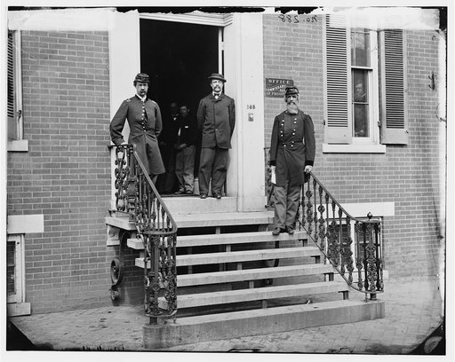 Washington, D.C. Gen. William Hoffman, Commissary General of Prisoners (at right) and staff on steps of office, F. St. at 20th NW