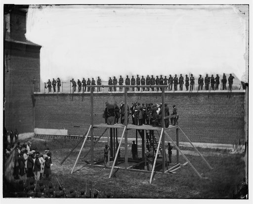 Washington, D.C. The four condemned conspirators (Mrs. Surratt, Payne, Herold, Atzerodt), with officers and others on the scaffold; guards on the wall
