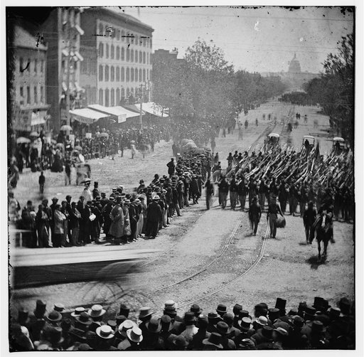Washington, D.C. Infantry unit with fixed bayonets followed by ambulances passing on Pennsylvania Avenue near the Treasury