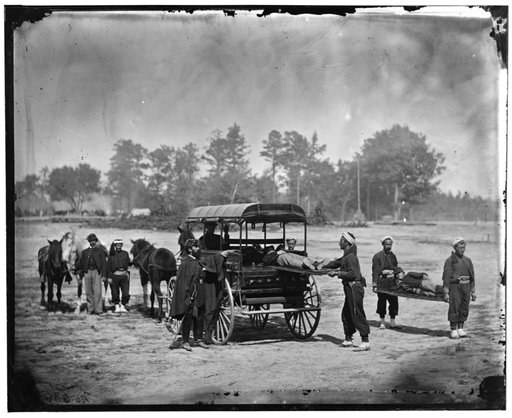 Unknown location. Zouave ambulance crew demonstrating removal of wounded soldiers from the field; another view