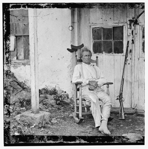 Gettysburg, Pennsylvania. John L. Burns, the "old hero of Gettysburg," with gun and crutches