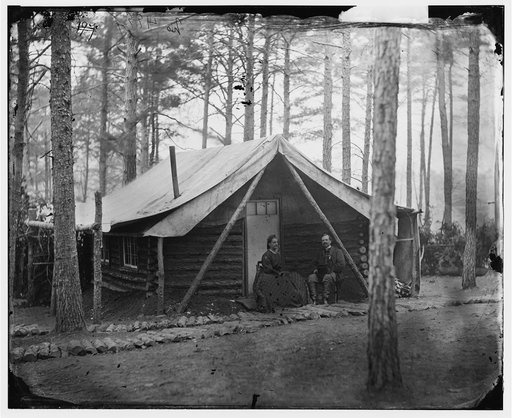 Brandy Station, Virginia. Col. John R. Coxe, A.C.S., and lady seated before his log-cabin winter quarters at Army of the Potomac headquarters
