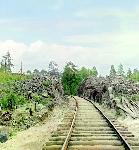 Cutting of a railroad near Kondopoaga Bay, with man standing beside tracks, Russia