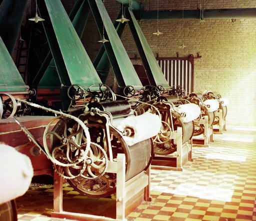 Cotton textile mill interior with machines producing cotton thread, probably in Tashkent