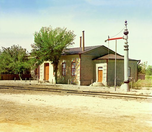 Railroad station with water crane and tracks