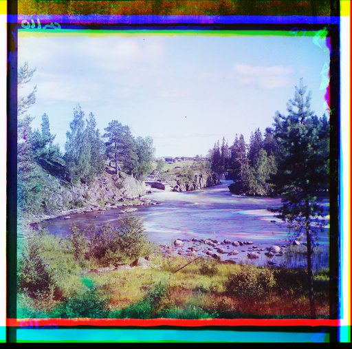 View of a river leading to waterfall, bridge and buildings