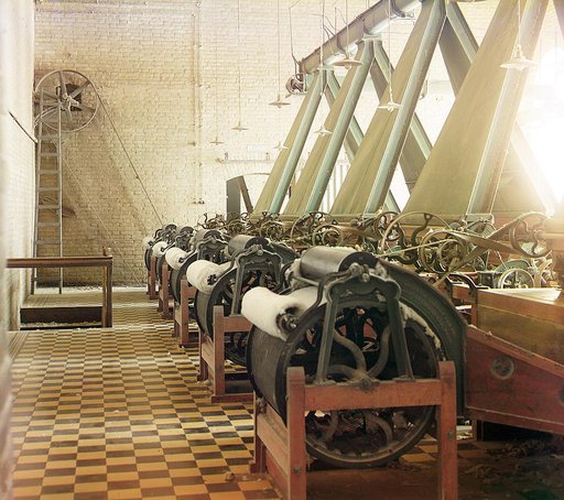 Cotton textile mill interior with machines producing cotton thread, probably in Tashkent