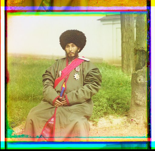 Isfandiyar, Khan of the Russian protectorate of Khorezm(Khiva), full-length portrait, in uniform, seated on chair, outdoors