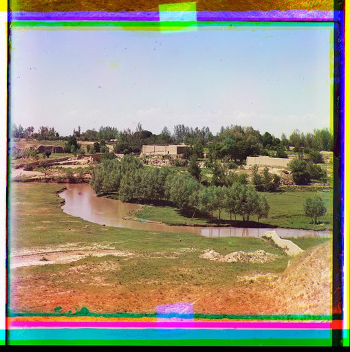 Adobe buildings along a vegetated stream