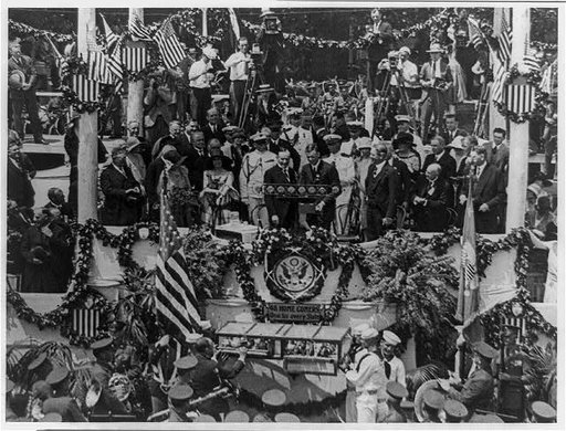 Charles A. Lindbergh speaking on flag-draped podium, with Calvin Coolidge