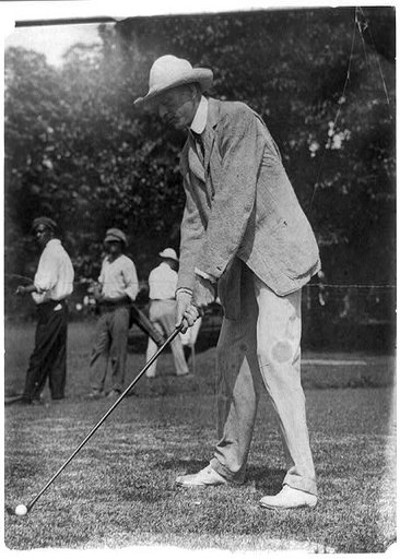 Tuckerman swinging at golf ball, Washington, D.C., area