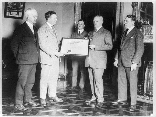 John J. Pershing and another man holding certificate of Nobility of Almas Temple, with three other men standing around them
