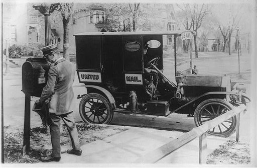 Mailman emptying mailbox, automobile marked "United Mail" at curb