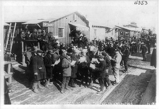 Noontime at canteen--reading the Hog Island News