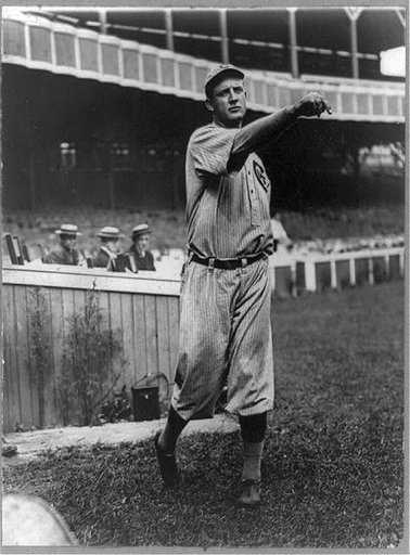 Orval Overall, baseball player for Chicago Cubs, throwing baseball in front of grandstand