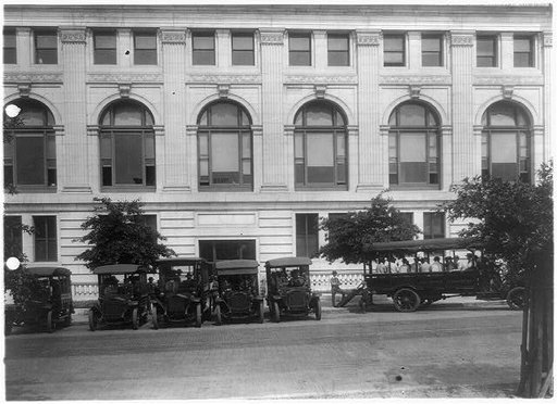Bus and mail(?) trucks in front of the Washington, D.C., Post Office