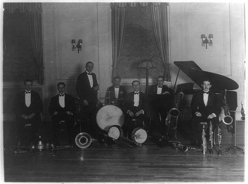 Group of seven musicians including Charlie Miller, Elwood Wilson, and Robert Blatt, probably members of a Washington, D.C. orchestra, in a hotel at 2400 16th St., N.W.