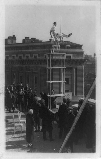 The "Human fly" otherwise known as John Reynolds giving an exhibition of his skill on the roof of the Times-Herald Bldg. Wash[ington] D.C.
