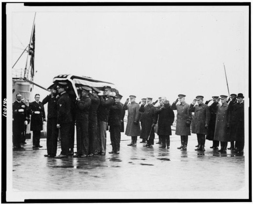 America's highest dignitaries of state, army and navy stand at salute while the casket containing the body of the unknown soldiers is borne to the casson [sic] taking it from the Navy Yard to the Capitol. In the group are General Pershing, Gen. Lejeune, commander of the Marine Corps, Gen. Harbord an