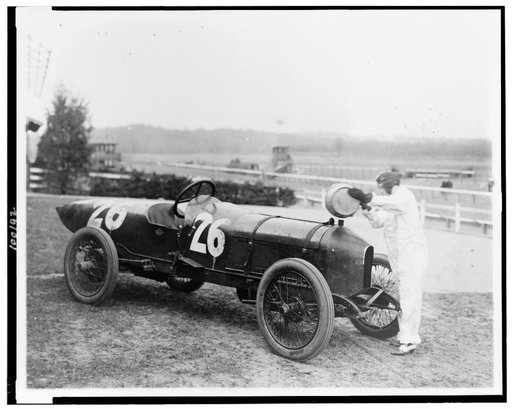 Woman putting water in radiator of Stutz Weightman Special no 26. on Benning race track, Washington, D.C., area