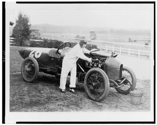 Woman working under hood of Stutz Weightman Special no. 26 on Benning race track, Washington, D.C., area