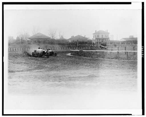 Stutz Weightman Special and another automobile going around turn on Benning race track, Washington, D.C., area on Thanksgiving Day