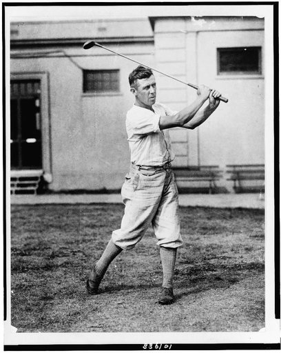 Man swinging golf club in the Washington, D.C., area(?)