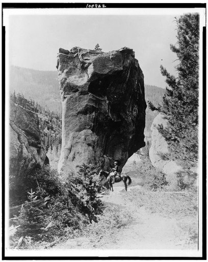 Man on horseback by butte in Rocky Mountain National Park, Colorado
