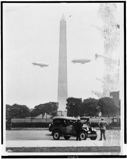 U.S. Army blimps, the T.C. 5 and T.C. 9 from Langley Field, Va. passing over the Washington Monument during a practice flight