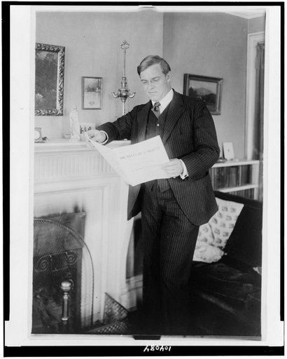 Thomas Hardie Chalmers, full-length portrait, standing by fireplace, facing left, looking at sheet music
