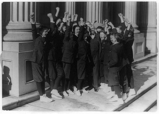 Vice President Thomas R. Marshall receiving a hearty cheer from Senate pages after he invited them to a Christmas dinner, standing on U.S. Capitol steps