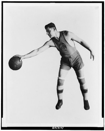 Basketball player of the Palace Club holding basketball upside down with one hand, Washington, D.C., area