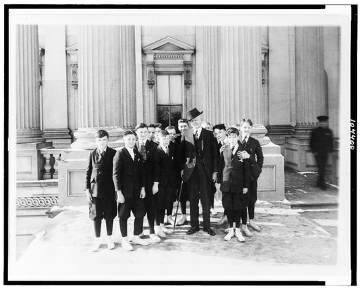 Vice Pres. Marshall will entertain the pages of the Senate at a Christmas party. Photo shows the Vice Pres. and the pages with whom he is very popular on the steps of the Capitol